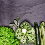Broccoli, celery, and celery stalks laid out on
